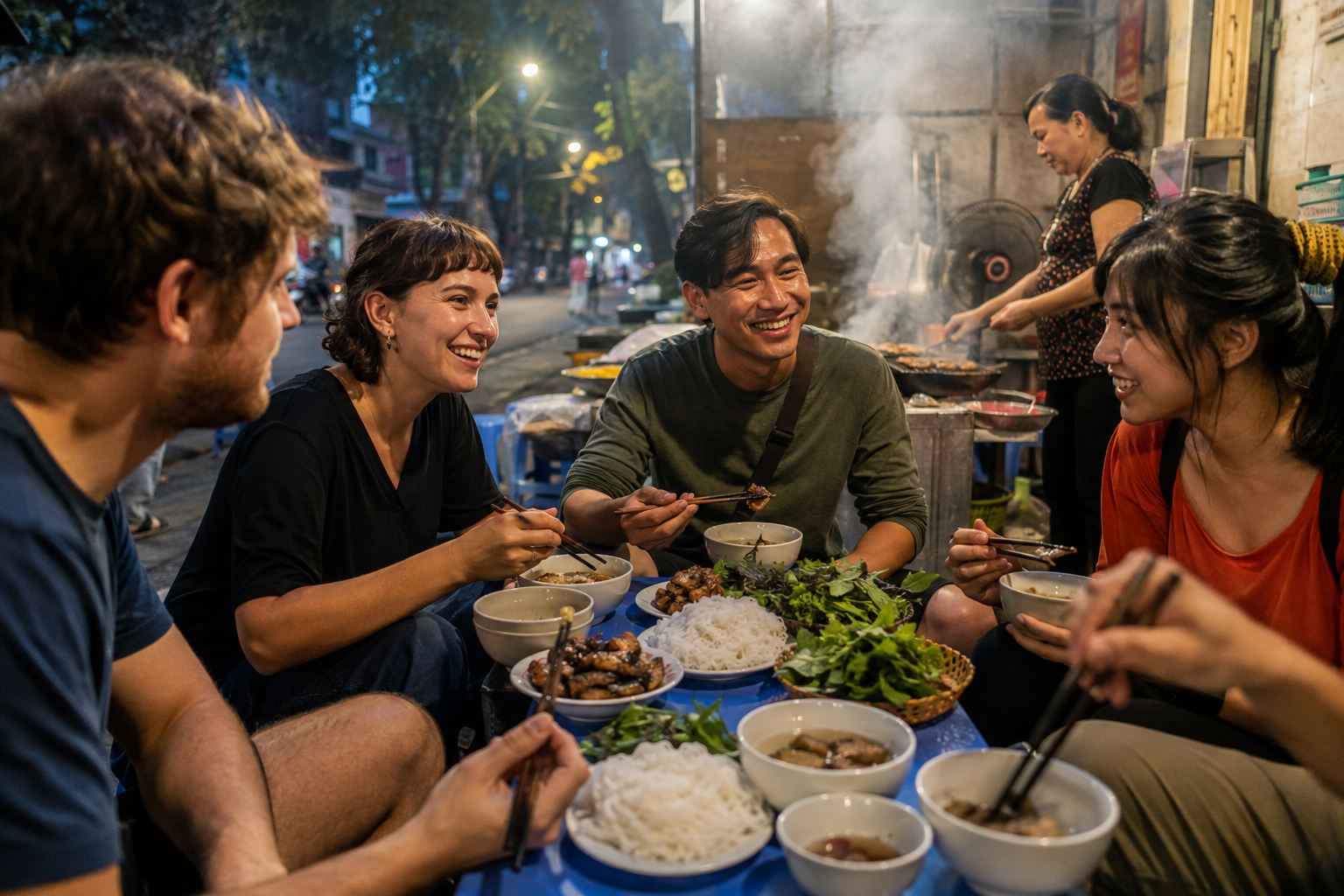 Travelers sharing bun cha during an evening food walk
